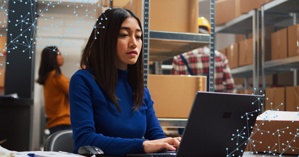 supply chain procurement specialist working at a laptop in warehouse