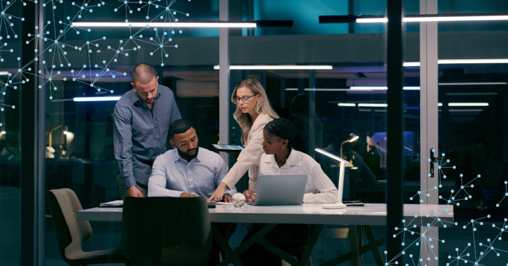 employees reviewing information on laptops in an office