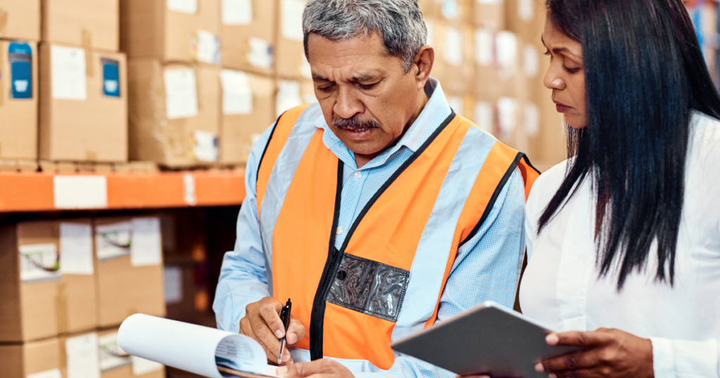 workers in a warehouse reviewing a service parts order